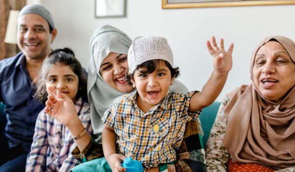 Muslim family relaxing and playing at home