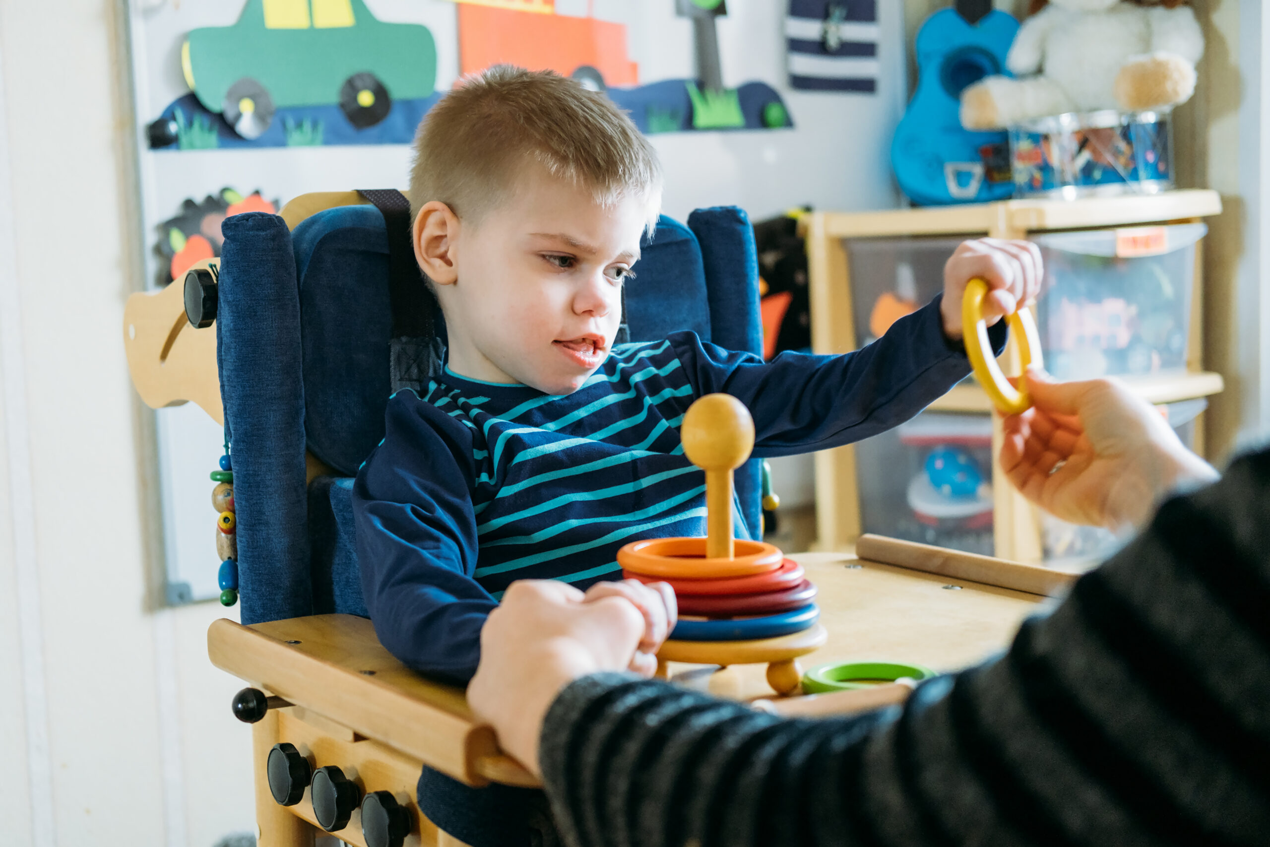 A boy sat playing with a toy