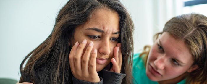 Girl consoling her sad friend