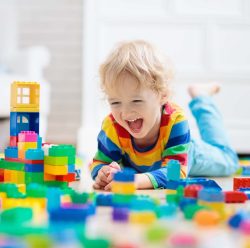 Photo of a Child Playing With Toy Blocks. Toys For Kids.