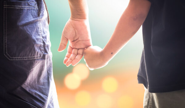 Child holding parents finger