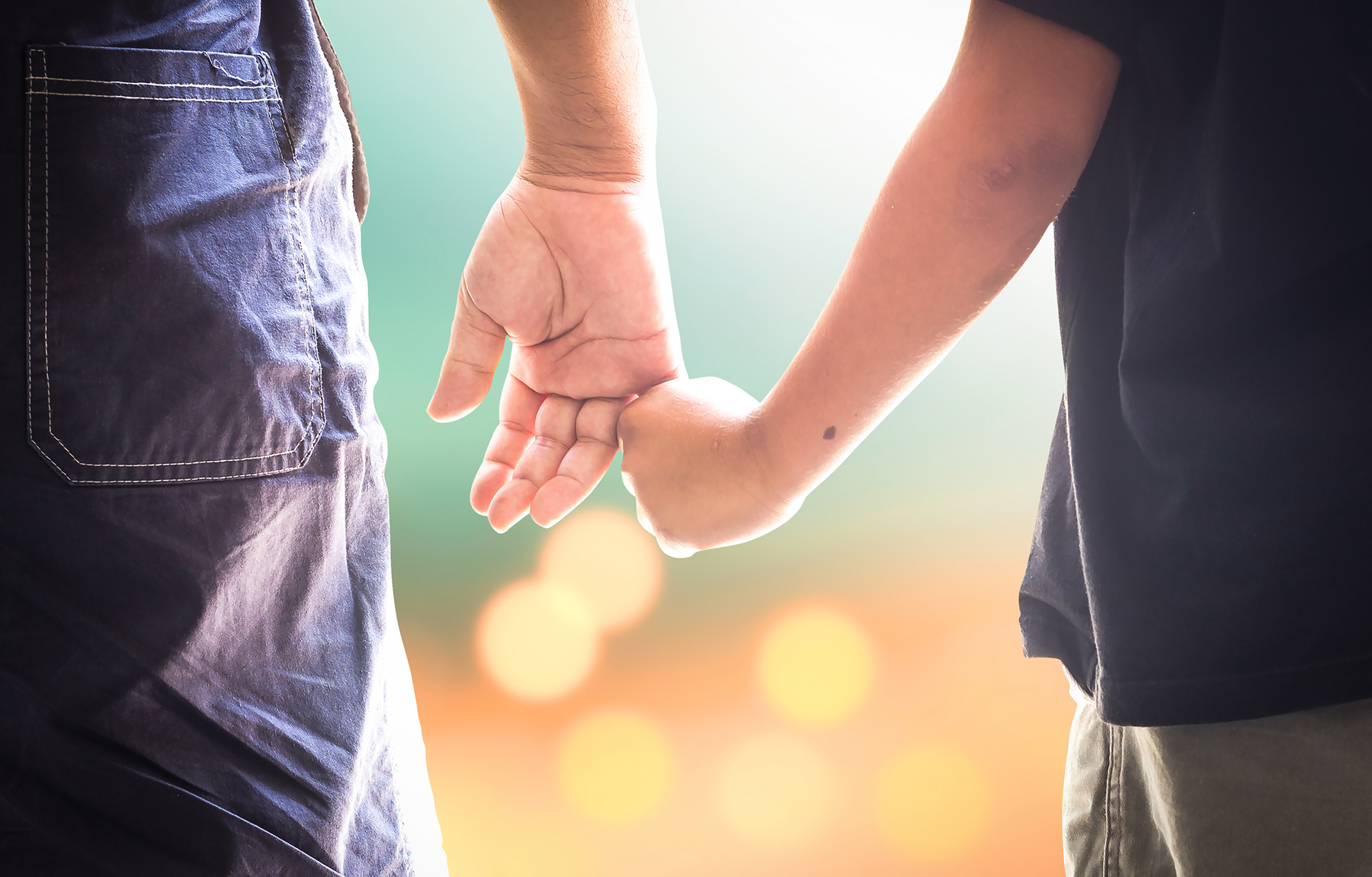 Child holding parents finger