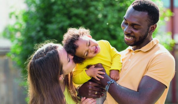 Multiracial mixed family concept. Black father and white mother