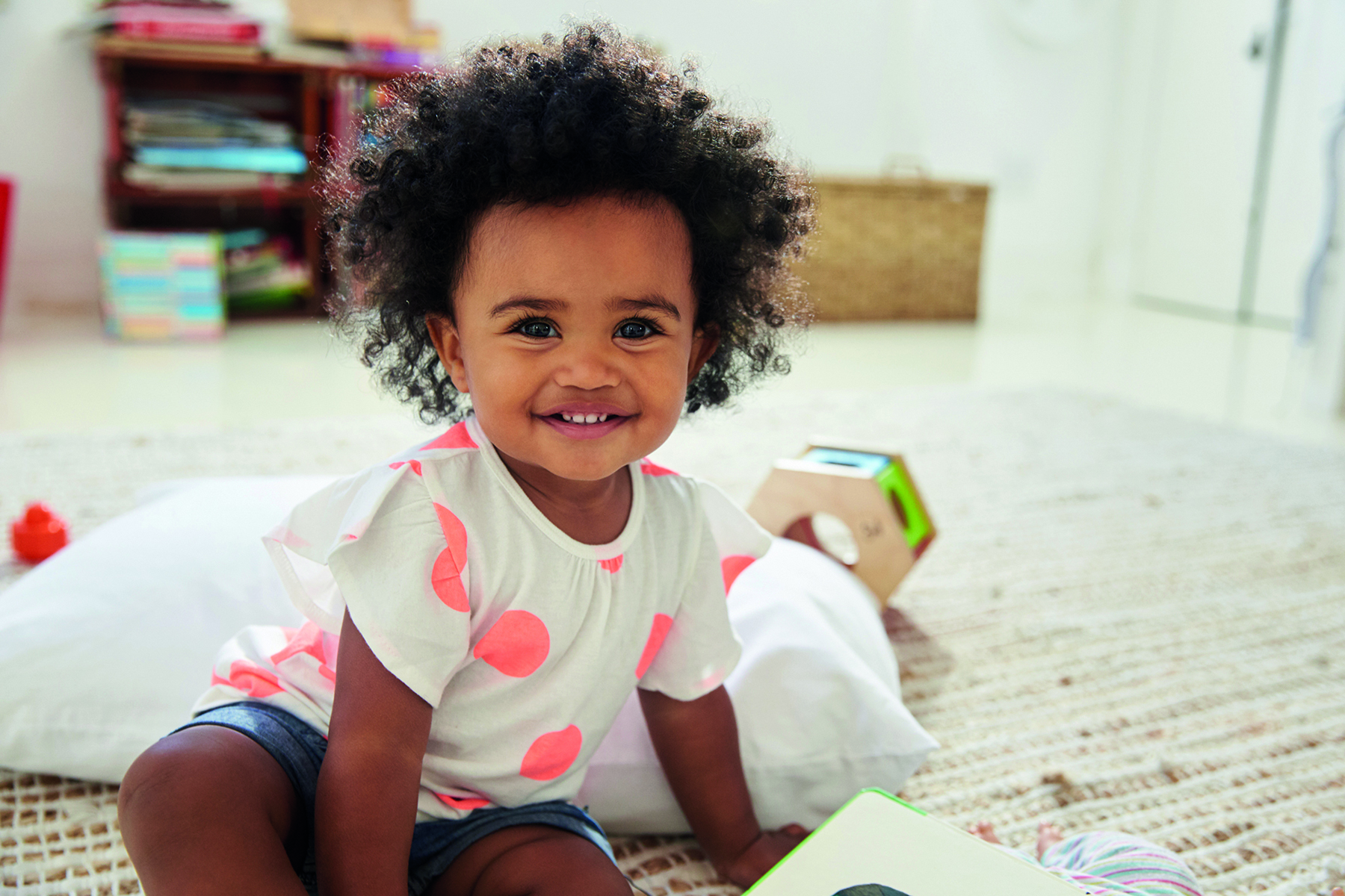 Happy Baby Girl Playing With Toys In Playroom