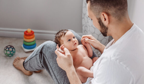 A dad holding a baby on his lap