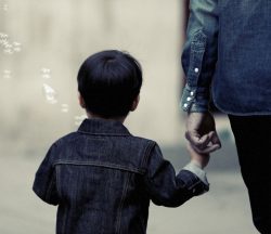child holding parents hand