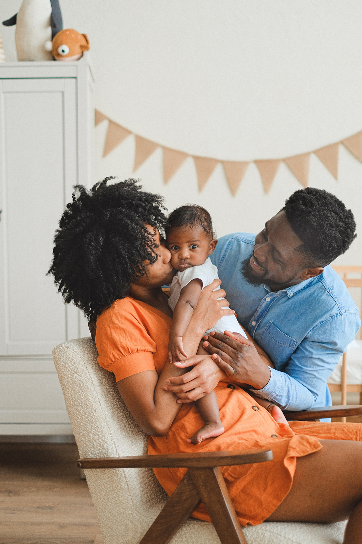 A mum and dad hugging a small child