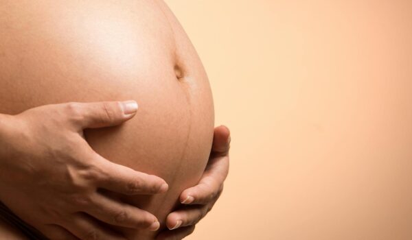 A woman holding her baby bump
