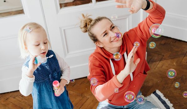 Woman and child blowing bubbles