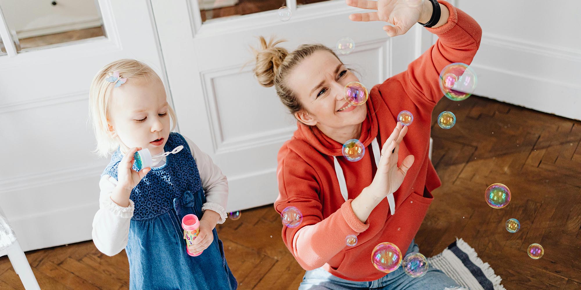 Woman and child blowing bubbles