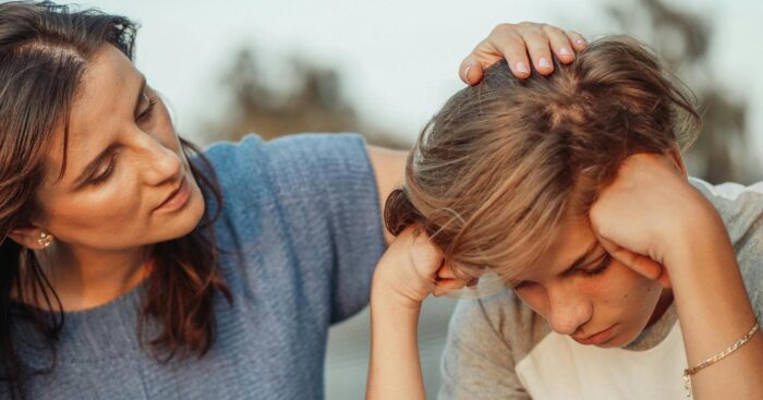 pexels-kindelmedia-8550841 Sad child with parent