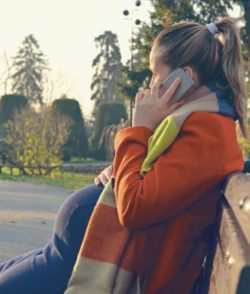 woman on bench on phone